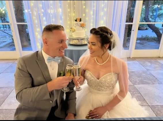 Bride and groom toasting at reception