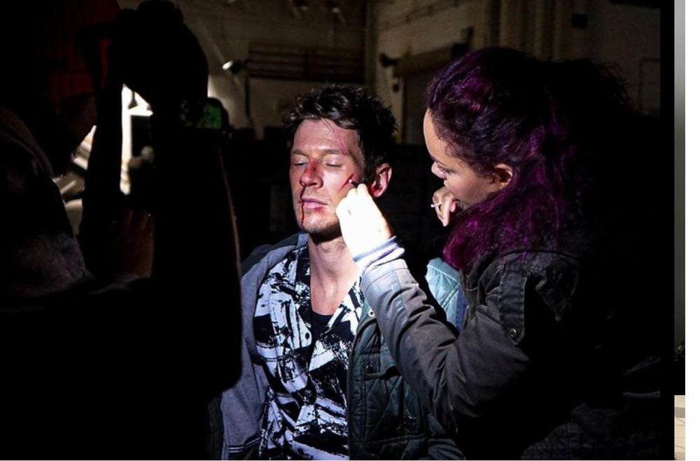 Applying makeup on set