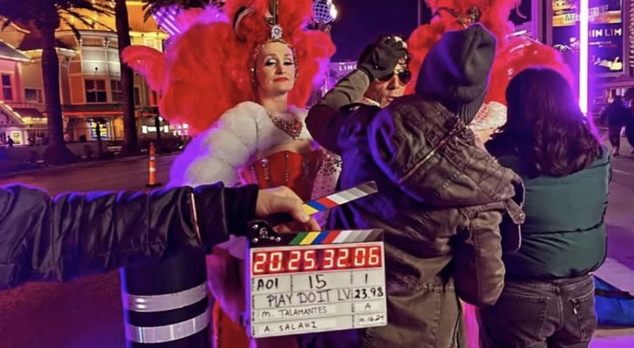 On set with clapperboard at a Rock Your Hair event