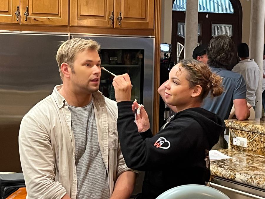 Applying makeup to a client on set